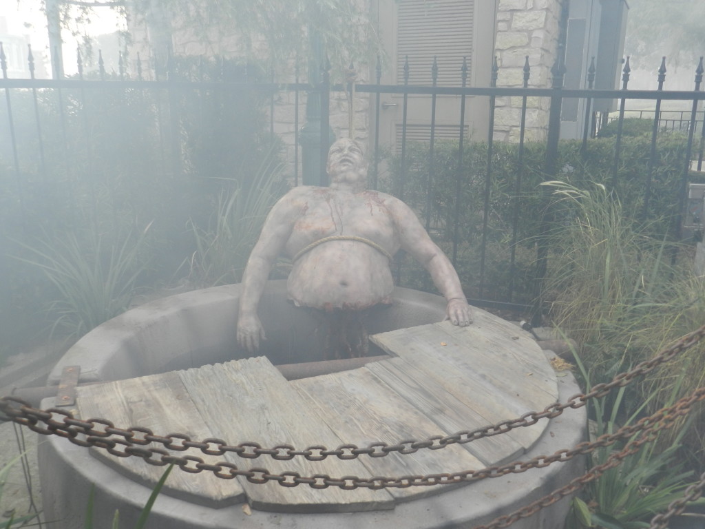 Halloween Horror Nights 2013 The Walking Dead Series Zombie in Well. Keep reading for more Halloween Horror Nights rumors and secrets!